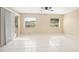 Bright living area featuring tile floors, neutral walls, and sliding glass door at 2126 Sabal Palm Dr, Edgewater, FL 32141