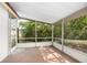 Enclosed screened patio with view of landscaped backyard at 2126 Sabal Palm Dr, Edgewater, FL 32141