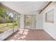 Enclosed patio with screen and glass windows and sliding glass door to the home's interior at 2126 Sabal Palm Dr, Edgewater, FL 32141
