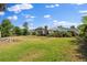 The spacious backyard shows a well-kept lawn and greenery with a chimney and screened-in porch for outdoor enjoyment at 2144 Brian Ave, South Daytona, FL 32119