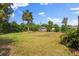 A large backyard features a lawn, mature trees, and a shed, offering plenty of space for recreation and gardening at 2144 Brian Ave, South Daytona, FL 32119