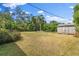 Expansive backyard featuring lush greenery, mature trees, and a charming shed, ideal for outdoor activities at 2144 Brian Ave, South Daytona, FL 32119