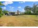 A sprawling backyard shows ample green space, a brick chimney, and a screened-in porch for outdoor living at 2144 Brian Ave, South Daytona, FL 32119