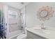Updated bathroom with marble-look tile shower, modern vanity, and stylish mirror at 2144 Brian Ave, South Daytona, FL 32119