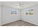 Well-lit bedroom with wood-look flooring and two windows with natural light at 2144 Brian Ave, South Daytona, FL 32119