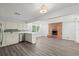 Stylish kitchen with stainless appliances, brick fireplace, and wood floors at 2144 Brian Ave, South Daytona, FL 32119
