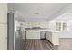 Bright kitchen with stainless steel appliances, white cabinets and tile backsplash at 2144 Brian Ave, South Daytona, FL 32119