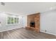Living room featuring a brick fireplace and large window for natural light at 2144 Brian Ave, South Daytona, FL 32119