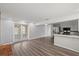 Open living space with updated kitchen, wood floors, and stainless appliances at 2144 Brian Ave, South Daytona, FL 32119
