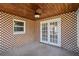 Covered patio with wood paneled ceiling and white lattice wall, overlooking the yard at 2144 Brian Ave, South Daytona, FL 32119