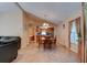 A spacious dining area features tile floors, a wooden table set, and views leading into the kitchen area at 2213 Needle Palm Dr, Edgewater, FL 32141