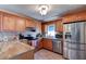 Updated kitchen featuring granite countertops, stainless steel appliances, and wood cabinetry at 2213 Needle Palm Dr, Edgewater, FL 32141