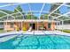 Backyard oasis with a screened-in pool, patio furniture, and a covered lanai for outdoor relaxation at 2213 Needle Palm Dr, Edgewater, FL 32141