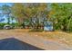 The expansive backyard features mature trees, two storage buildings, and vehicle parking at 2214 Danforth Ave, Deltona, FL 32738
