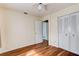 Bedroom featuring wood floors, ceiling fan, and closet space at 2214 Danforth Ave, Deltona, FL 32738