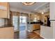 Functional kitchen with light wood cabinets and access to a screened in porch at 2214 Danforth Ave, Deltona, FL 32738