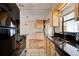 Galley kitchen with granite countertops and stainless steel appliances at 2214 Danforth Ave, Deltona, FL 32738
