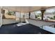 Covered patio with privacy curtains offers an outdoor living space and access to the detached garage at 2214 Danforth Ave, Deltona, FL 32738