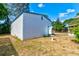 A detached utility shed with a white exterior, blue trim, and a single entry door at 2214 Danforth Ave, Deltona, FL 32738