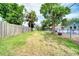 Fenced backyard with grassy lawn and mature trees, offering privacy at 2254 Green St, South Daytona, FL 32119