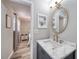 Bathroom with vanity, marble countertops and gold faucet, view to bedroom with queen bed at 2254 Green St, South Daytona, FL 32119