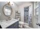 Well decorated bathroom featuring a marble countertop vanity and a shower with gray marble tiling at 2254 Green St, South Daytona, FL 32119