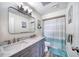 Bathroom featuring a double sink vanity, marble countertops, and a shower with a blue and white curtain at 2254 Green St, South Daytona, FL 32119