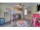 Bright bedroom with a bed and desk loft, flower rug, and a ceiling fan at 2254 Green St, South Daytona, FL 32119
