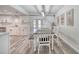 Dining area with an eat-in kitchen features white cabinets, subway tiles, and modern flooring at 2254 Green St, South Daytona, FL 32119