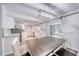 Dining area with an eat-in kitchen features white cabinets, subway tiles, and modern flooring at 2254 Green St, South Daytona, FL 32119