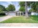 Charming one-story home featuring a well-manicured lawn, attached garage, and inviting front porch with arched entryways at 2254 Green St, South Daytona, FL 32119