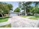 Inviting one-story home with a large driveway, attached garage, well-maintained lawn, and covered front porch at 2254 Green St, South Daytona, FL 32119
