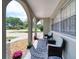 Covered porch with comfortable seating, stylish rug, and potted plants, enhancing the home's curb appeal at 2254 Green St, South Daytona, FL 32119