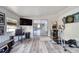Comfortable recreation room featuring wood-look flooring, a flat-screen television, and an arcade game at 2254 Green St, South Daytona, FL 32119