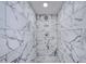 Shower stall featuring striking gray marble tiling and a mosaic tiled floor at 2254 Green St, South Daytona, FL 32119