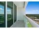 Balcony featuring city views and glass railings, providing an open and airy outdoor space at 231 Riverside Dr # 2310, Holly Hill, FL 32117