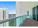 Condo balcony showcasing stunning city and waterfront views with modern glass railings and clear skies at 231 Riverside Dr # 2310, Holly Hill, FL 32117