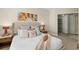 Cozy bedroom features a plush bed, modern art and an organized closet at 231 Riverside Dr # 2310, Holly Hill, FL 32117