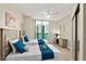 Cozy bedroom with two twin beds and sliding glass doors to a balcony with city views at 231 Riverside Dr # 2310, Holly Hill, FL 32117