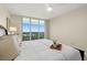 A bright bedroom with a large window offering beautiful city views at 231 Riverside Dr # 2310, Holly Hill, FL 32117