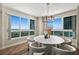 Bright dining area with modern white furniture, natural light, and expansive windows boasting scenic views at 231 Riverside Dr # 2310, Holly Hill, FL 32117