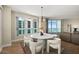 Well-lit dining room with stylish white seating and large windows offering serene waterfront and city views at 231 Riverside Dr # 2310, Holly Hill, FL 32117