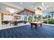 Inviting game room featuring a pool table, comfortable seating, and large windows with pleasant outdoor views at 231 Riverside Dr # 2310, Holly Hill, FL 32117