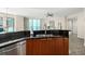 Kitchen featuring stainless steel appliances, wood cabinets, and a bar with a large sink at 231 Riverside Dr # 2310, Holly Hill, FL 32117