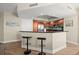 Modern kitchen featuring a breakfast bar, stainless steel appliances, wood cabinets and black countertops at 231 Riverside Dr # 2310, Holly Hill, FL 32117