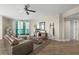 Open-concept living room with a large window, modern furniture, and hardwood flooring at 231 Riverside Dr # 2310, Holly Hill, FL 32117