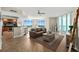 Bright living room with modern furniture, sleek flooring, expansive windows, and an adjacent dining area at 231 Riverside Dr # 2310, Holly Hill, FL 32117