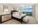 Bright main bedroom features a large window, a ceiling fan, and stylish furnishings at 231 Riverside Dr # 2310, Holly Hill, FL 32117