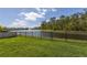 Expansive green lawn with a lake view and black metal fence at 258 Sandoval Dr, Ormond Beach, FL 32174