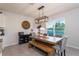 Bright dining room features a rustic wood table set and modern light fixture at 258 Sandoval Dr, Ormond Beach, FL 32174